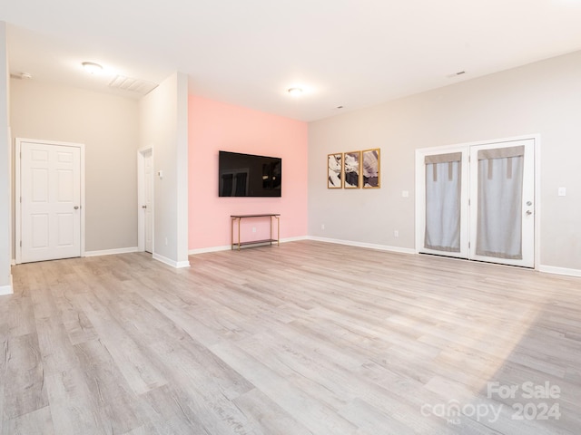 unfurnished living room with light hardwood / wood-style flooring