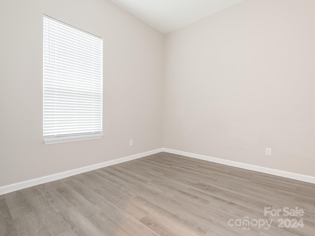 unfurnished room with light hardwood / wood-style flooring