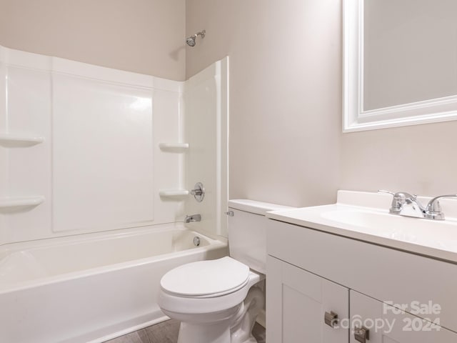 full bathroom with hardwood / wood-style flooring, vanity, shower / bathtub combination, and toilet