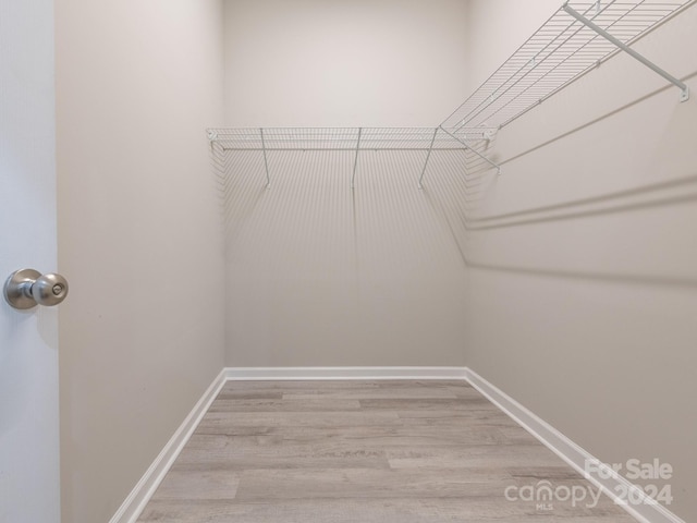 spacious closet featuring hardwood / wood-style floors