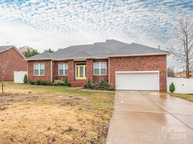 single story home with a garage and a front yard