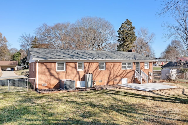 back of house with a lawn, cooling unit, and a patio area