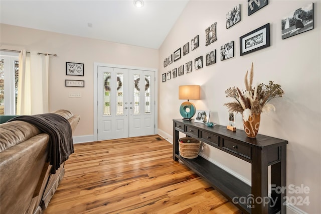 foyer with light hardwood / wood-style flooring and vaulted ceiling