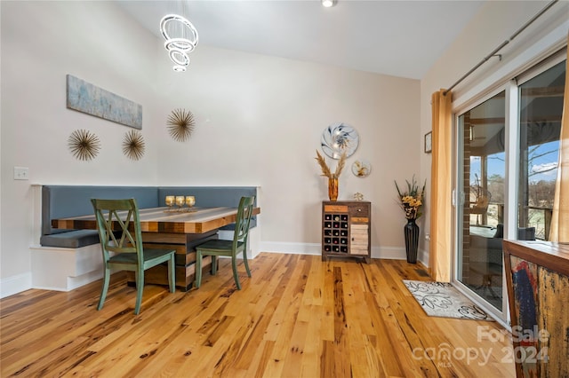 dining area featuring light hardwood / wood-style floors and vaulted ceiling