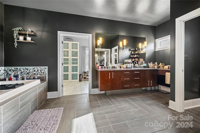 bathroom with vanity and a relaxing tiled tub