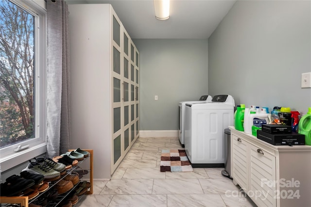 clothes washing area featuring independent washer and dryer and a wealth of natural light