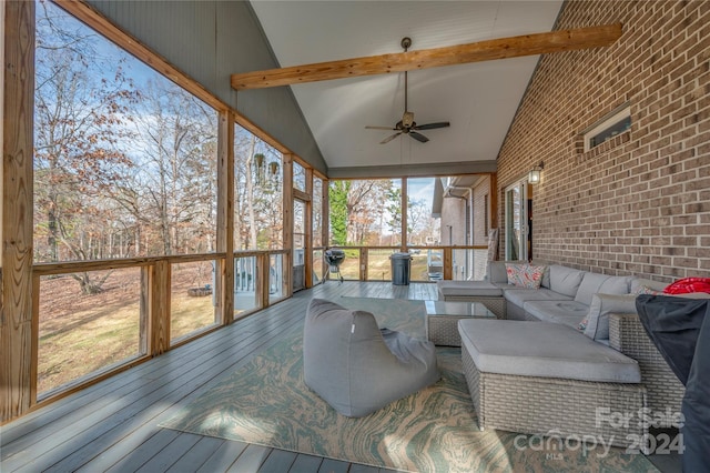 sunroom / solarium featuring vaulted ceiling with beams and ceiling fan