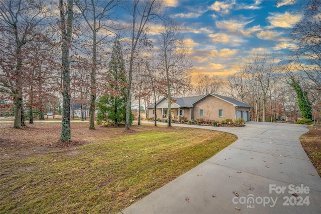 view of front of property featuring a garage and a yard