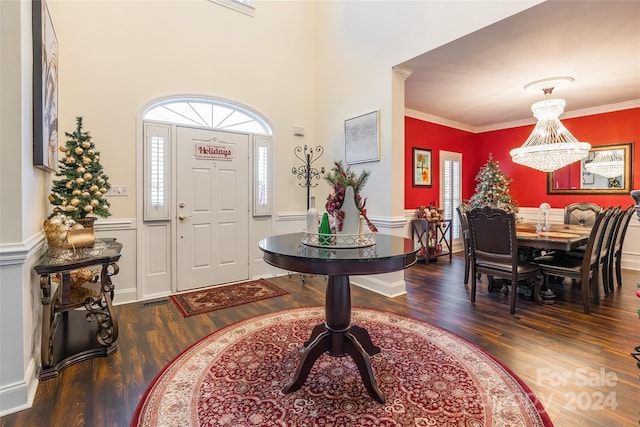 foyer entrance featuring dark hardwood / wood-style flooring and ornamental molding