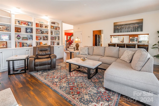 living room featuring crown molding and dark wood-type flooring