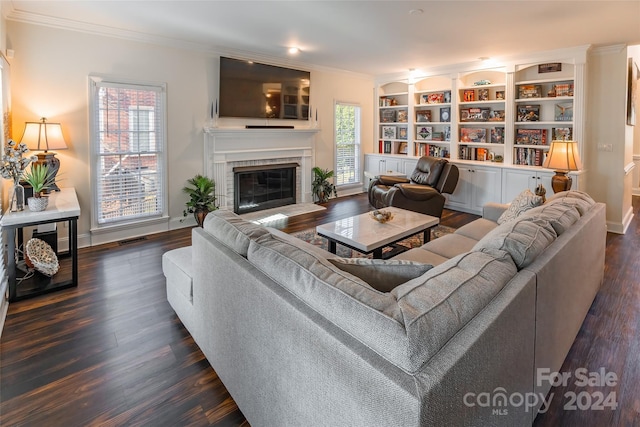 living room featuring plenty of natural light, a fireplace, and dark wood-type flooring