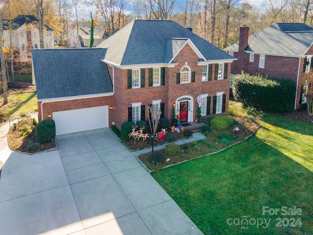 view of front of property with a garage and a front yard