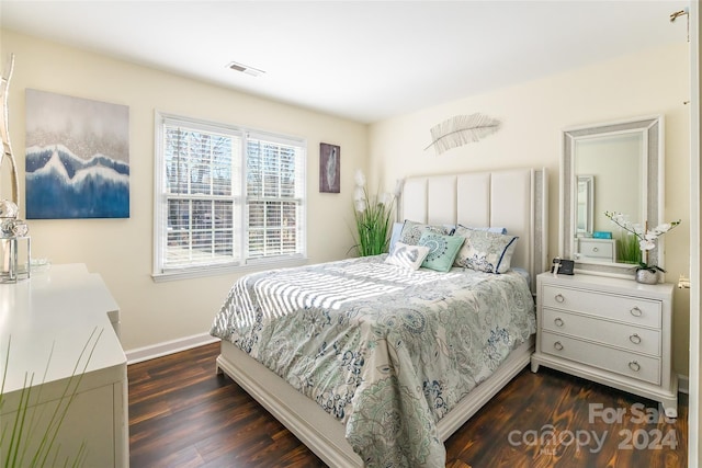 bedroom with dark wood-type flooring