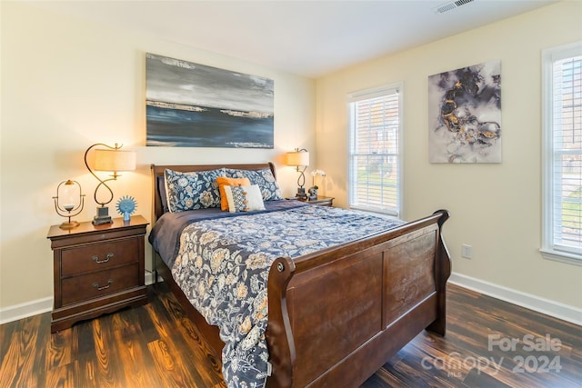 bedroom with dark wood-type flooring