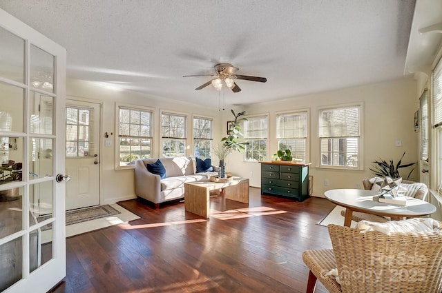 sunroom / solarium with ceiling fan, french doors, and a healthy amount of sunlight