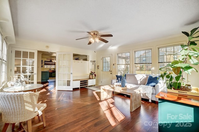 living room with french doors, ceiling fan, and dark wood-type flooring