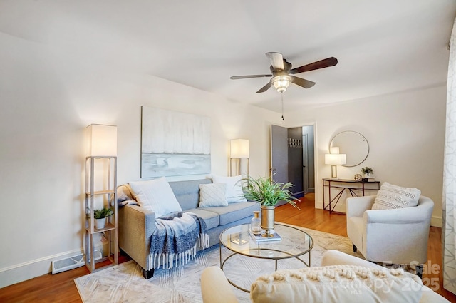 living room with ceiling fan and wood-type flooring