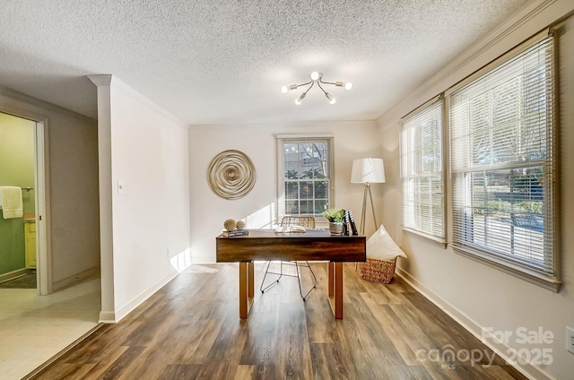 office space with an inviting chandelier, a textured ceiling, and hardwood / wood-style flooring