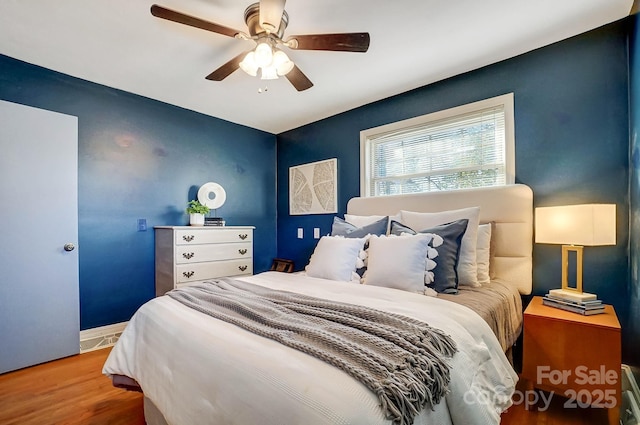 bedroom featuring ceiling fan and hardwood / wood-style floors