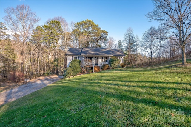 ranch-style home with a front lawn and covered porch