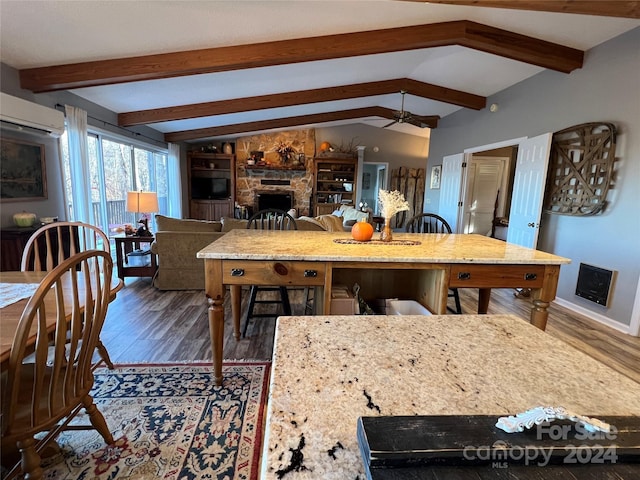 kitchen with ceiling fan, a fireplace, lofted ceiling with beams, and dark hardwood / wood-style floors