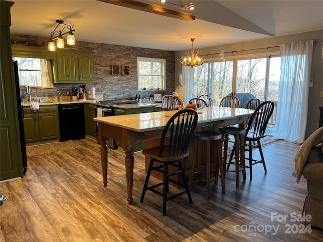 dining space with lofted ceiling, hardwood / wood-style flooring, and a notable chandelier