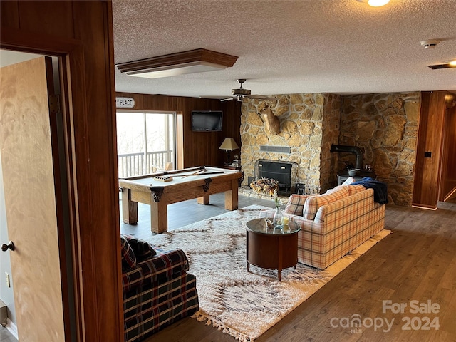 living room featuring a textured ceiling, hardwood / wood-style flooring, ceiling fan, and billiards