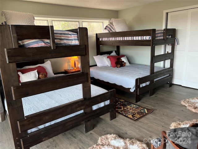 bedroom with hardwood / wood-style flooring and a textured ceiling