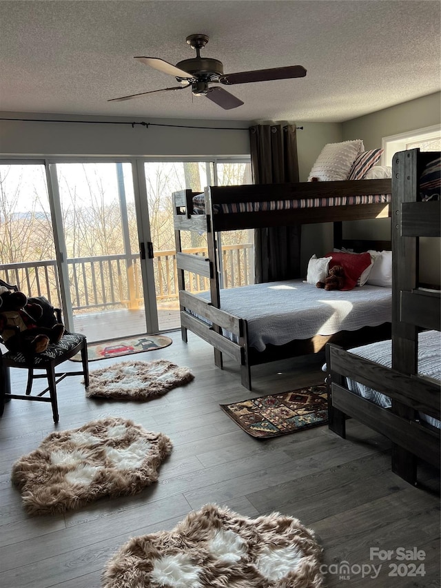 bedroom with ceiling fan, access to exterior, wood-type flooring, and a textured ceiling