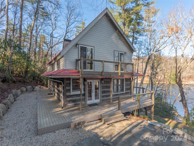 back of house featuring french doors and a deck