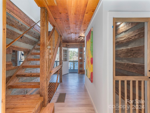 corridor featuring hardwood / wood-style floors and wood ceiling