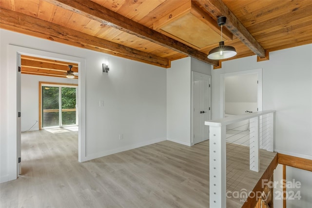 empty room featuring beam ceiling, light hardwood / wood-style floors, ceiling fan, and wooden ceiling