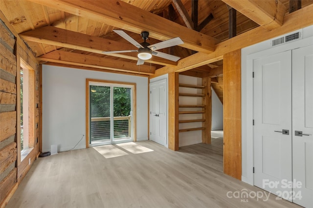 unfurnished living room featuring vaulted ceiling with beams, ceiling fan, light hardwood / wood-style floors, and wooden ceiling