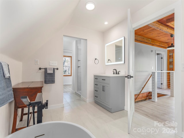 bathroom featuring a bathing tub, vanity, wood-type flooring, and wood ceiling