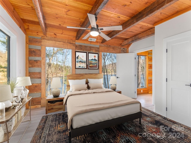 bedroom with ceiling fan, beamed ceiling, and wooden ceiling