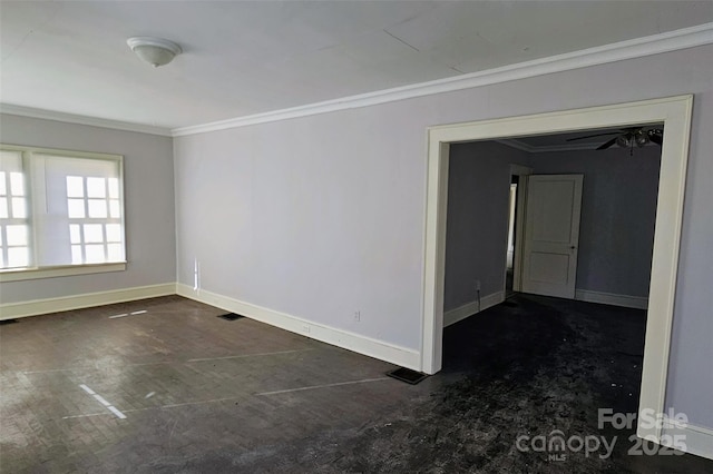 empty room featuring crown molding