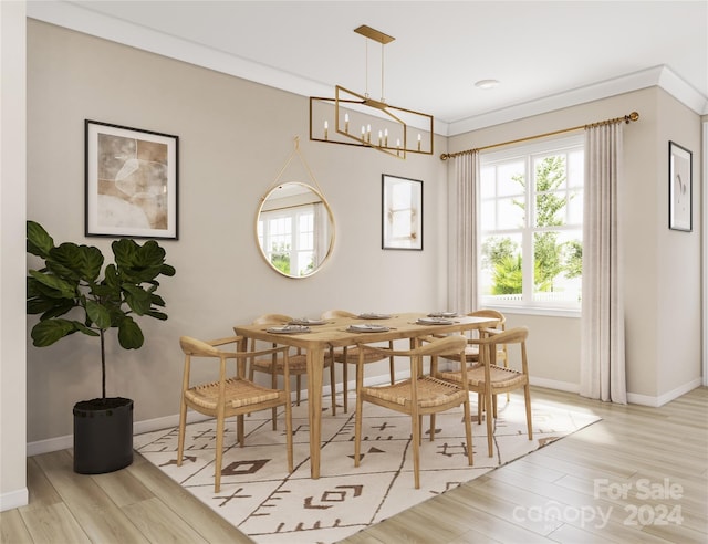 dining area featuring light hardwood / wood-style floors, ornamental molding, and a chandelier