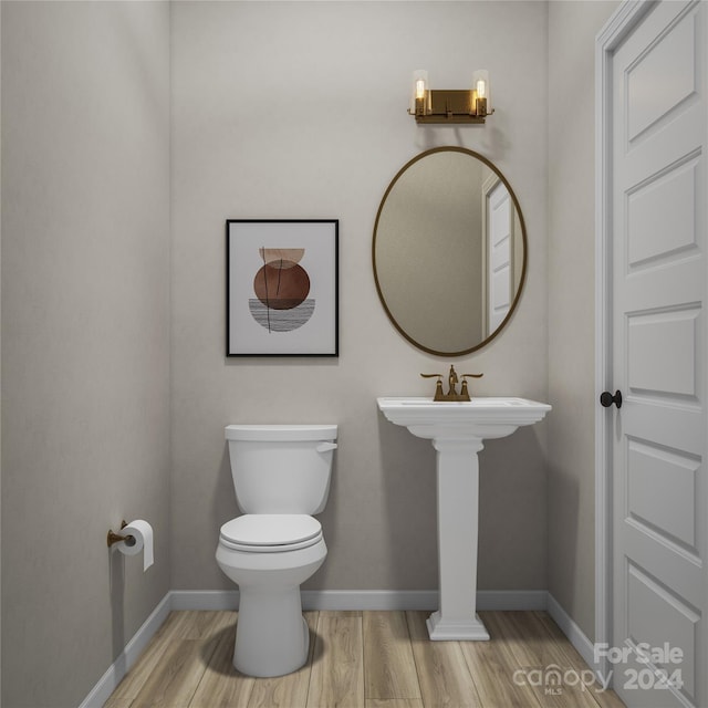 bathroom featuring toilet and wood-type flooring