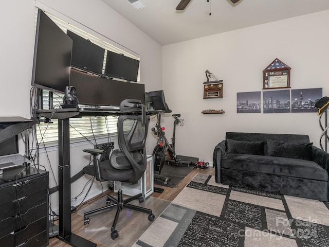 home office with dark hardwood / wood-style floors and ceiling fan