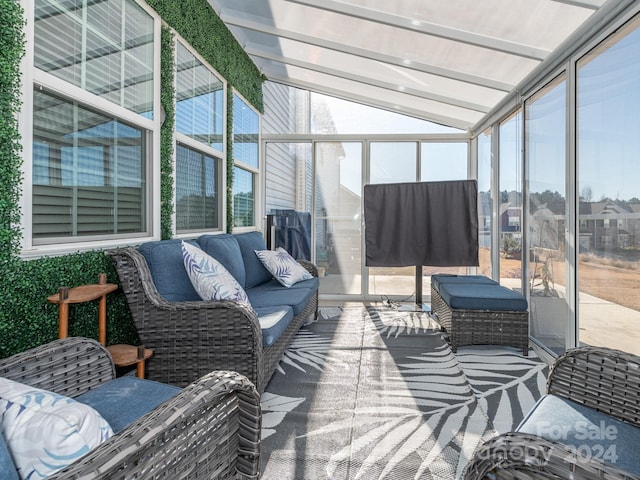 sunroom featuring vaulted ceiling