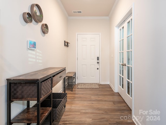 doorway with french doors, hardwood / wood-style flooring, and ornamental molding