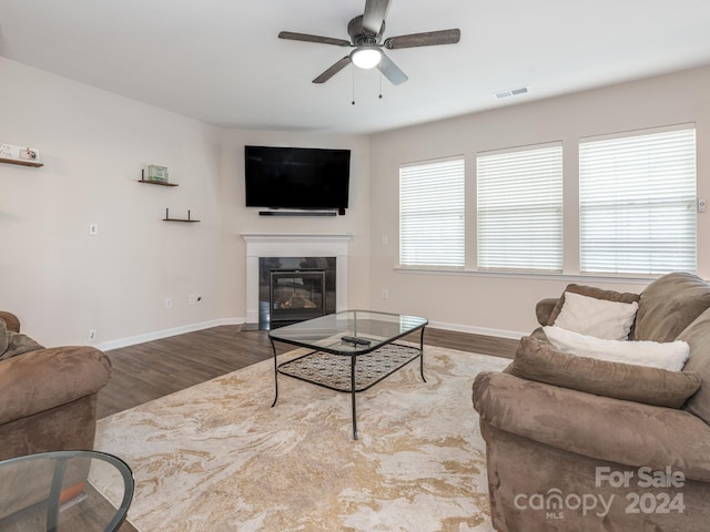 living room featuring hardwood / wood-style floors and ceiling fan