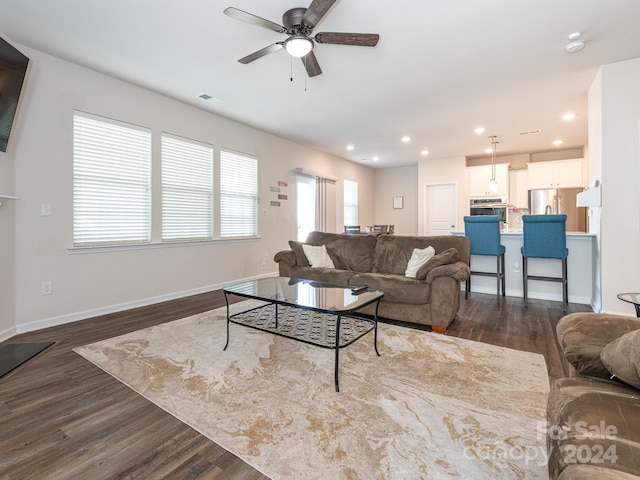 living room with dark hardwood / wood-style floors and ceiling fan