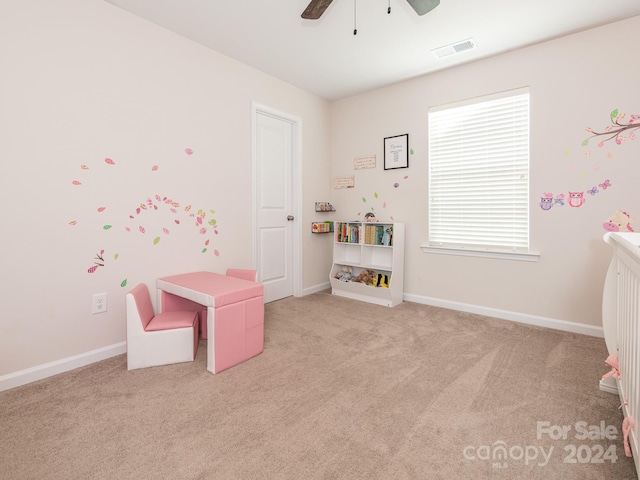 playroom with ceiling fan and light colored carpet