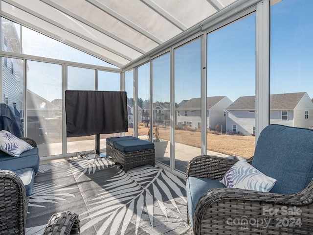 sunroom / solarium featuring lofted ceiling