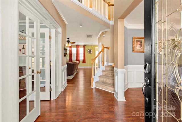 foyer featuring ceiling fan, crown molding, dark wood-type flooring, and french doors