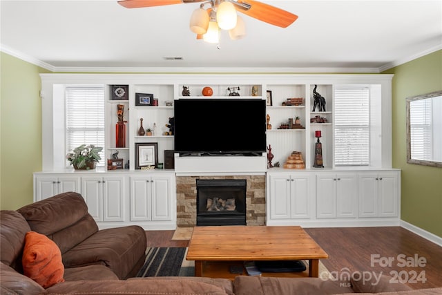 living room with ceiling fan, a fireplace, dark wood-type flooring, and ornamental molding