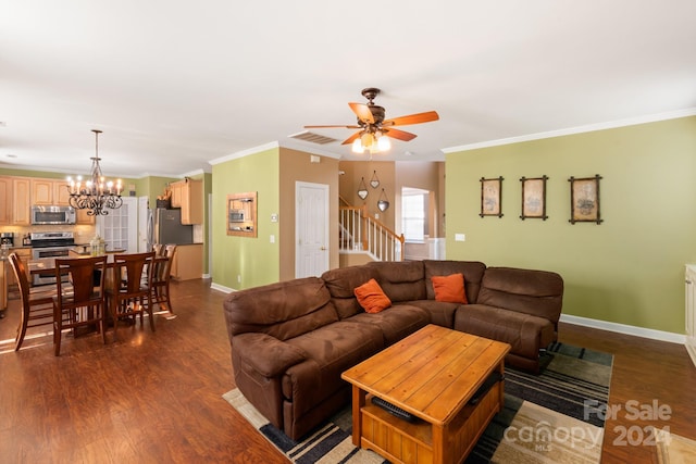 living room featuring crown molding, dark hardwood / wood-style flooring, and ceiling fan with notable chandelier