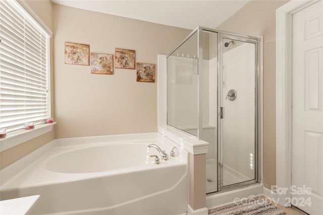 bathroom featuring separate shower and tub