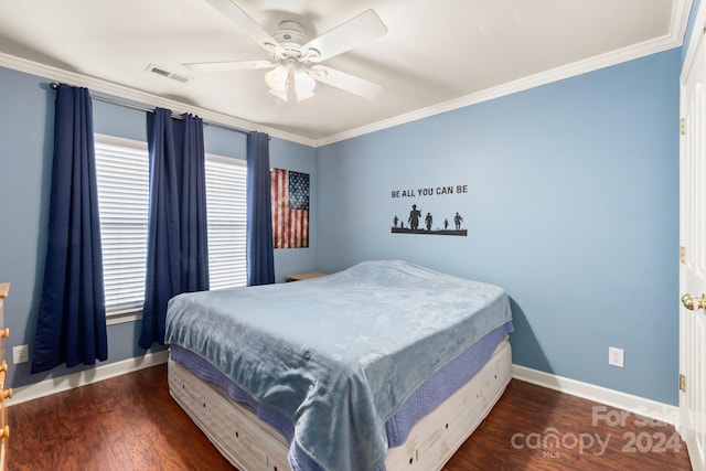 bedroom with ornamental molding, ceiling fan, and dark wood-type flooring